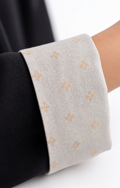 Close-up of the grey contrast sleeve cuffs featuring a delicate micro-floral pattern
