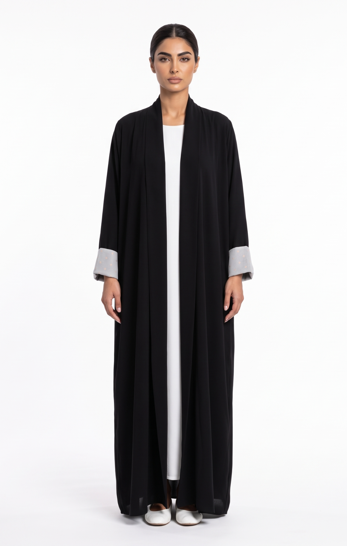 Full-length front view of a classic black open-front abaya with patterned contrast cuffs