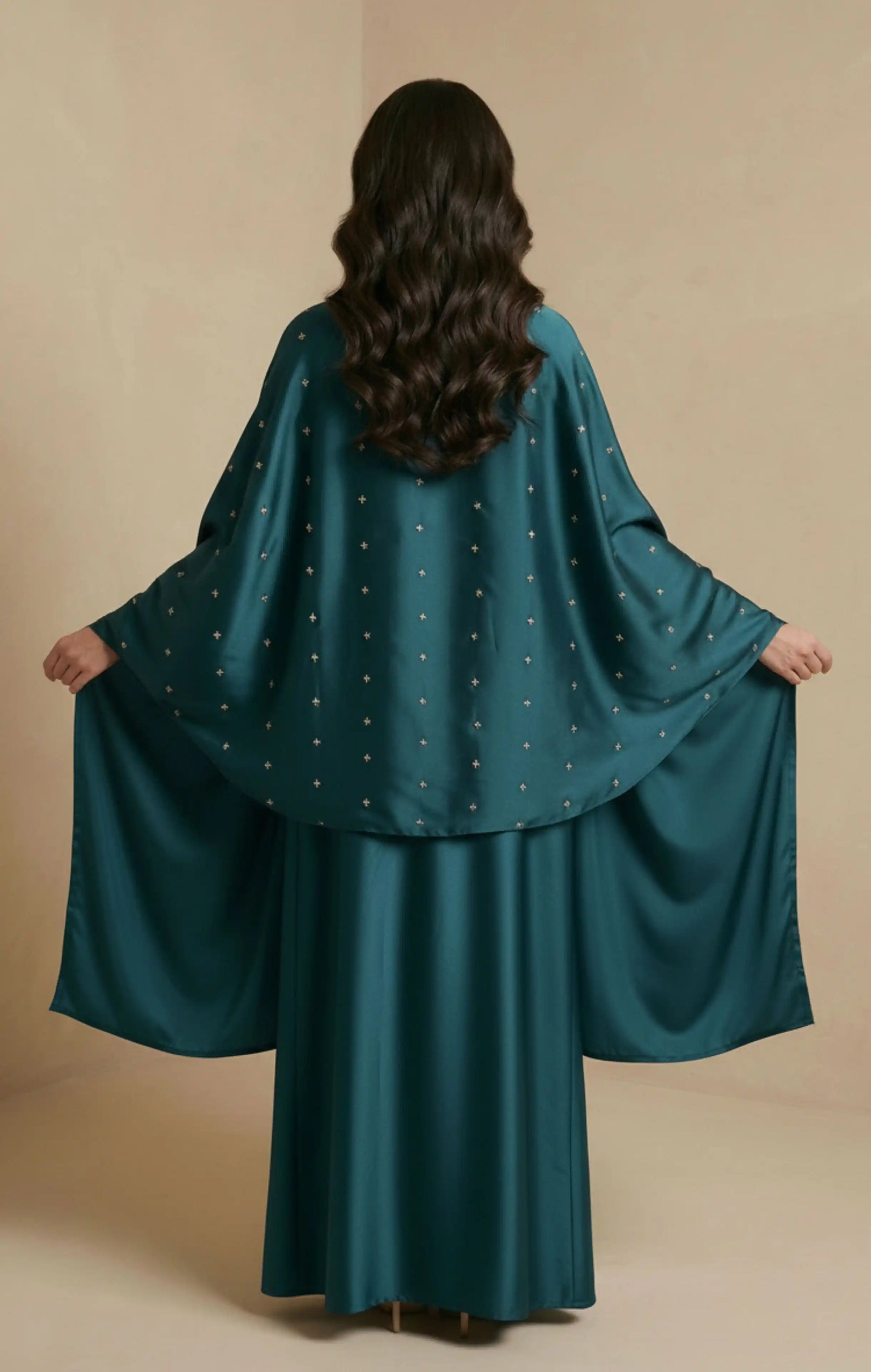 HIRAZ in green Crafted from luxurious crepe silk, it features a soft, flowing drape  delicate hand embroidery in gold an attached shawl extends from the garment