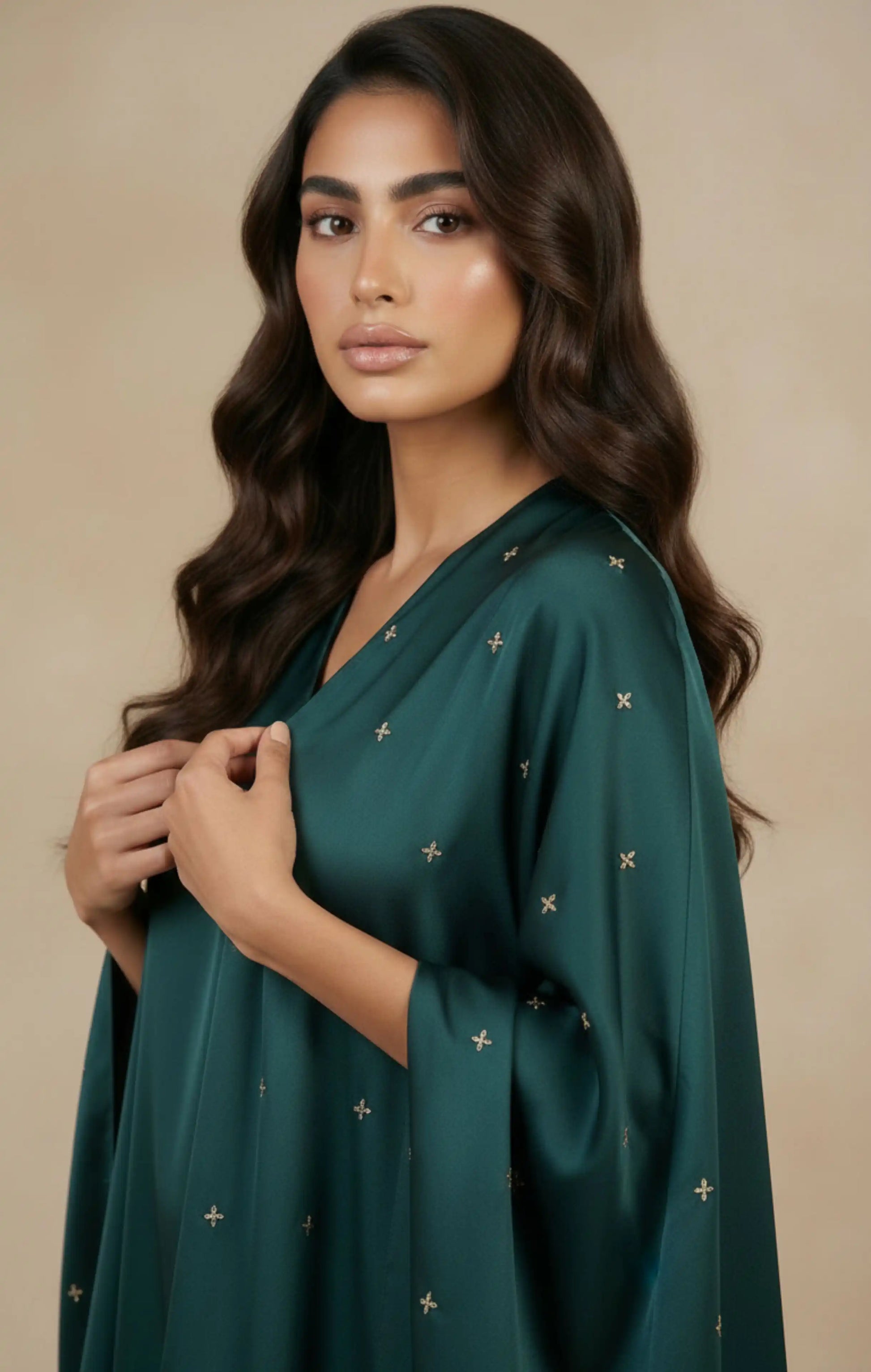 HIRAZ in green Crafted from luxurious crepe silk, it features a soft, flowing drape  delicate hand embroidery in gold an attached shawl extends from the garment