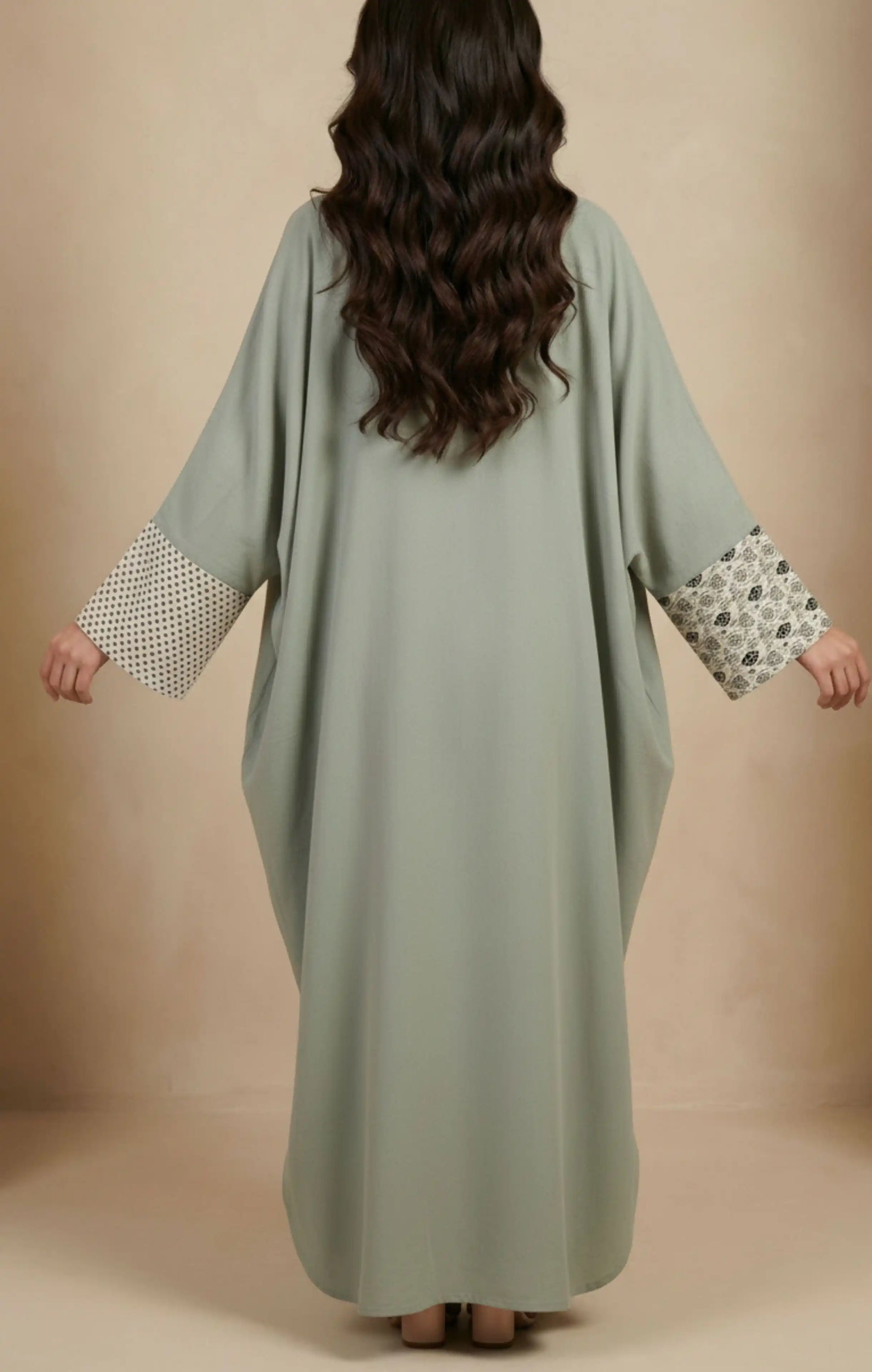 Two-piece modest abaya with a patterned cotton-silk front panel featuring vertical detailing, worn over a solid-color inner dress.